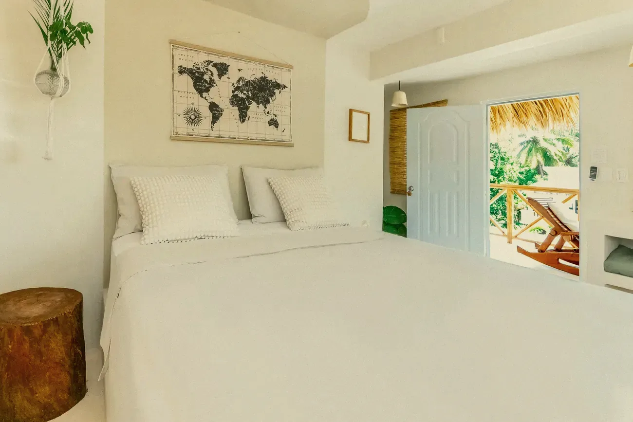 A bedroom opening onto a balcony with a lounger