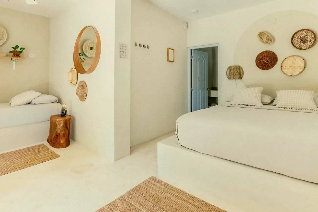 A bedroom with a double and a single bed and its own bathroom