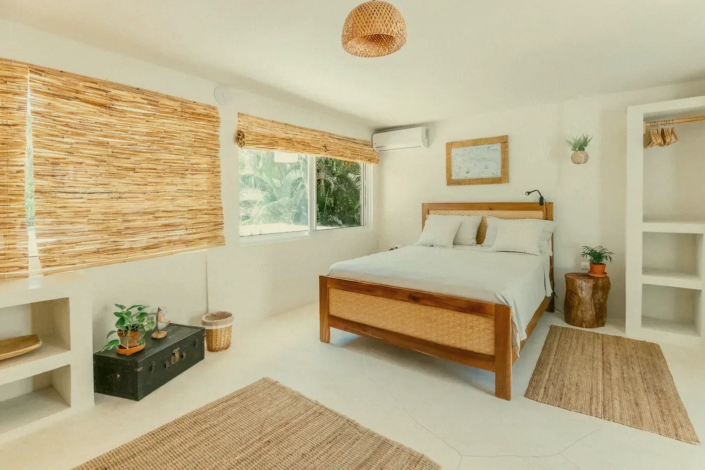 A bedroom with a wooden bed and bamboo blinds