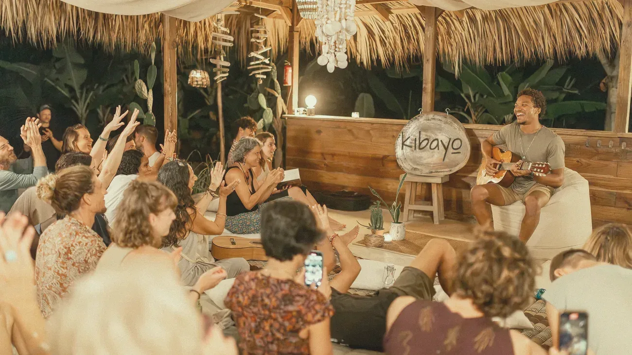 A guitarist playing for a group in the garden